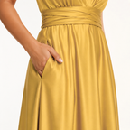 color:Gold | Close-up of a woman wearing a satin-like mustard yellow dress with a gathered waistband and side pocket, shown against a plain light background.